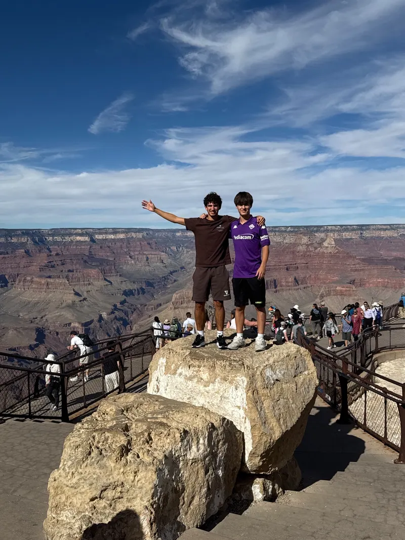 Two friends standing together at a canyon overlook