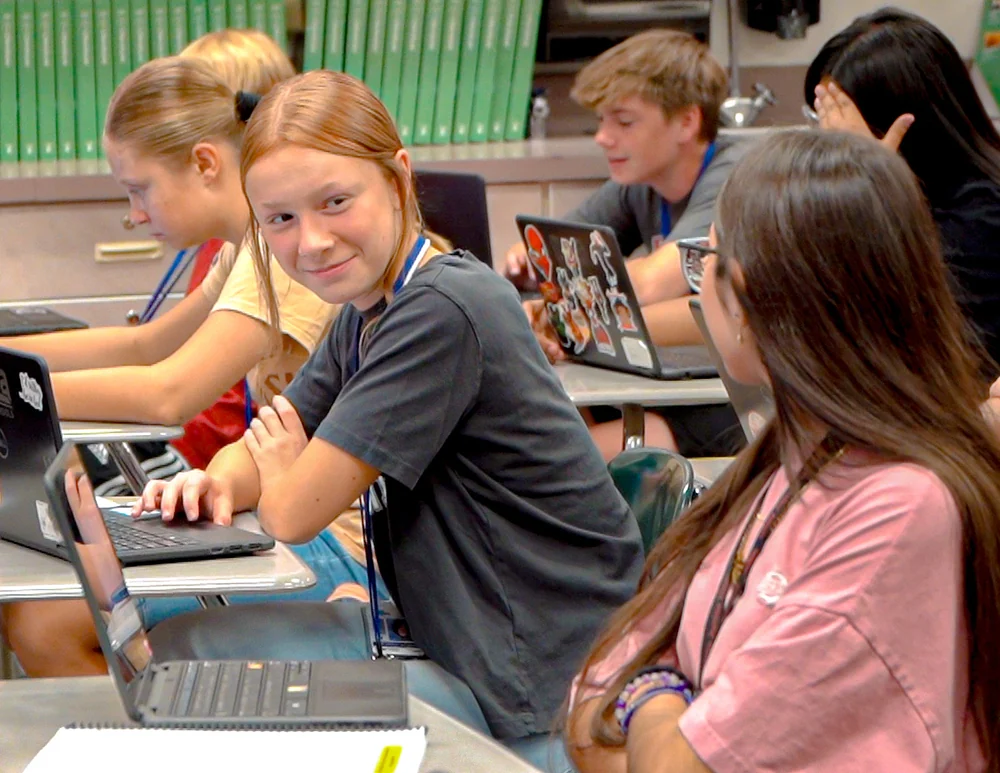 Students working on laptops in a classroom, pictured in Mesa Public Schools district news