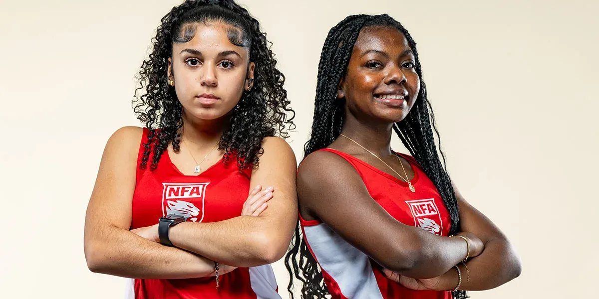 Two Norwich Free Academy athletes in red school uniforms in Norwich, Connecticut